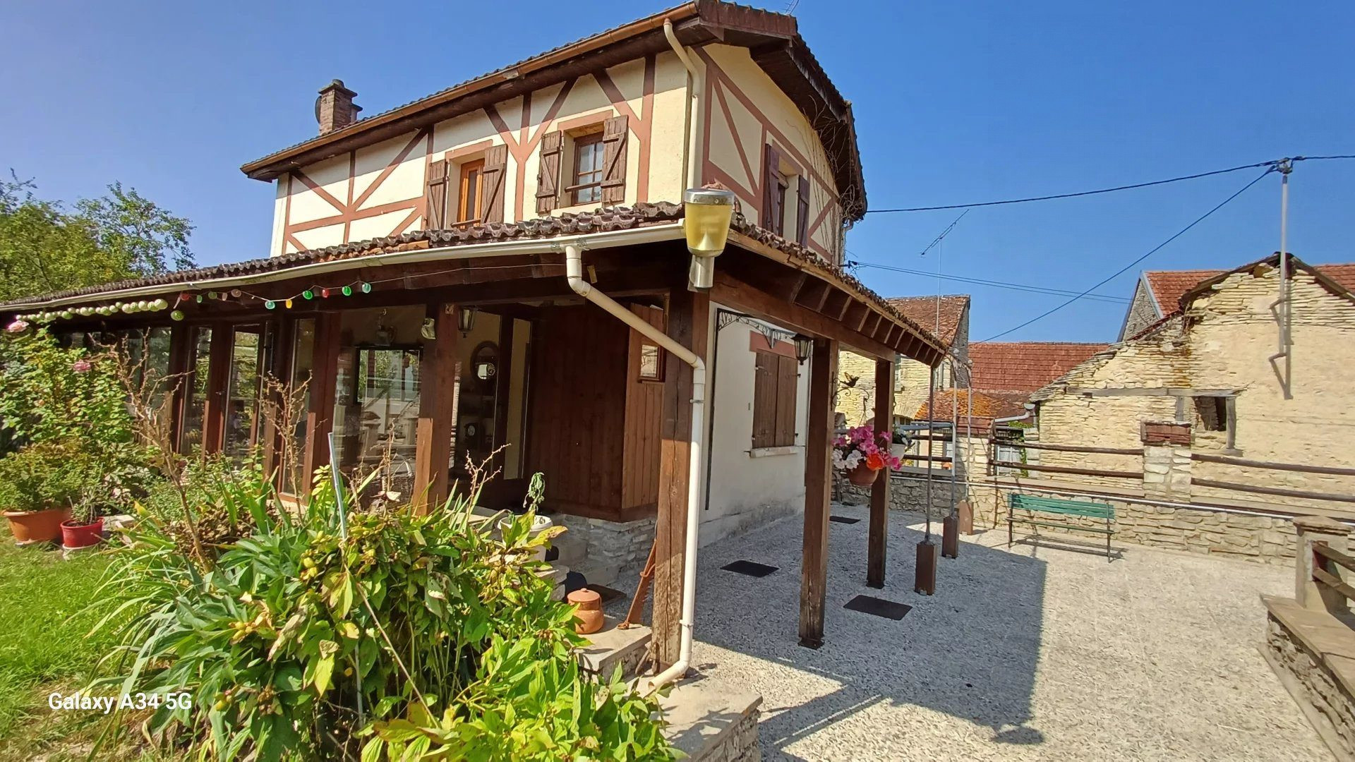 Character home with atypical and original architecture nestled in a verdant setting in the heart of the village. 2