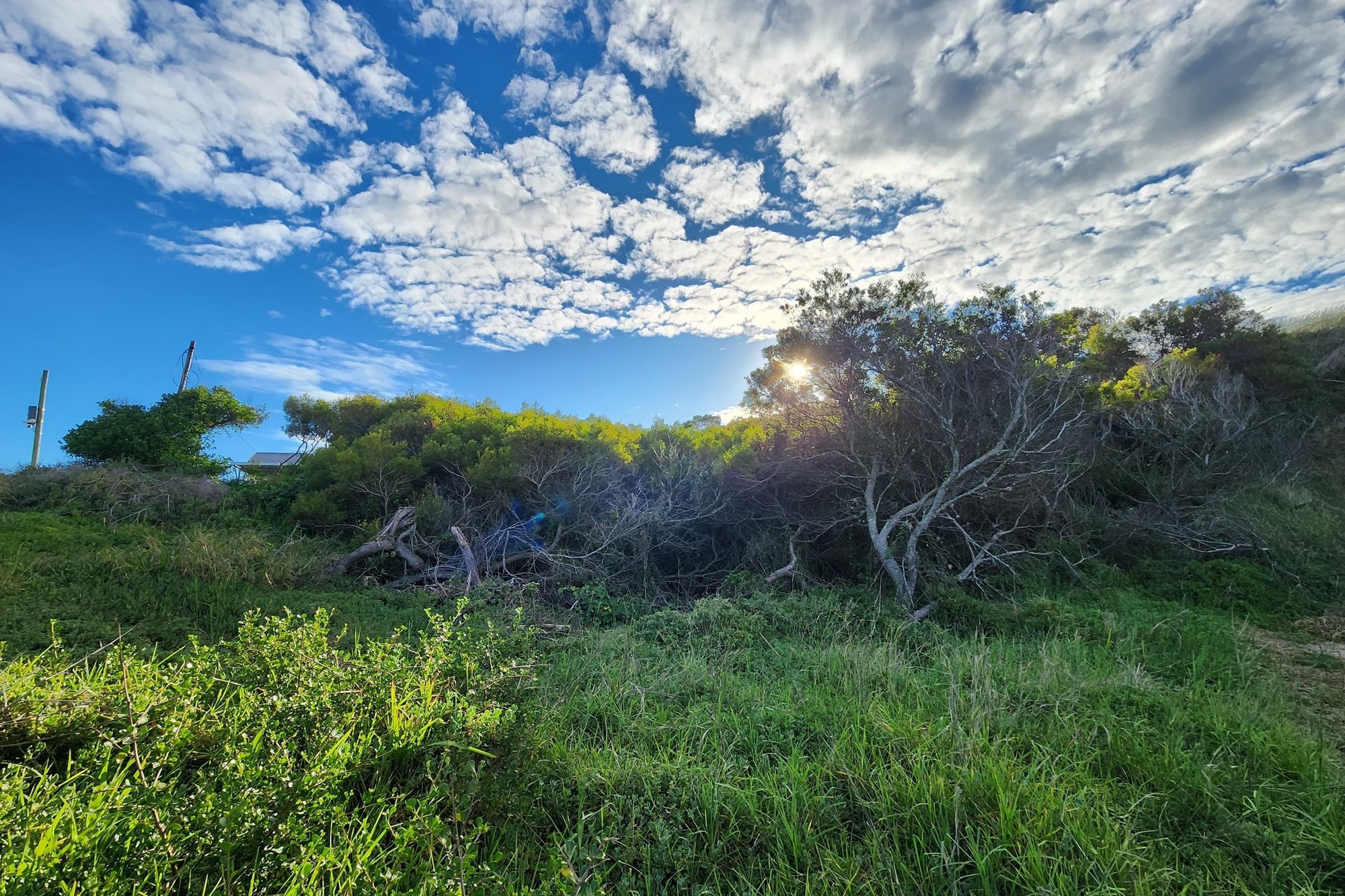 Plot for sale in Paradise Beach with distant sea view