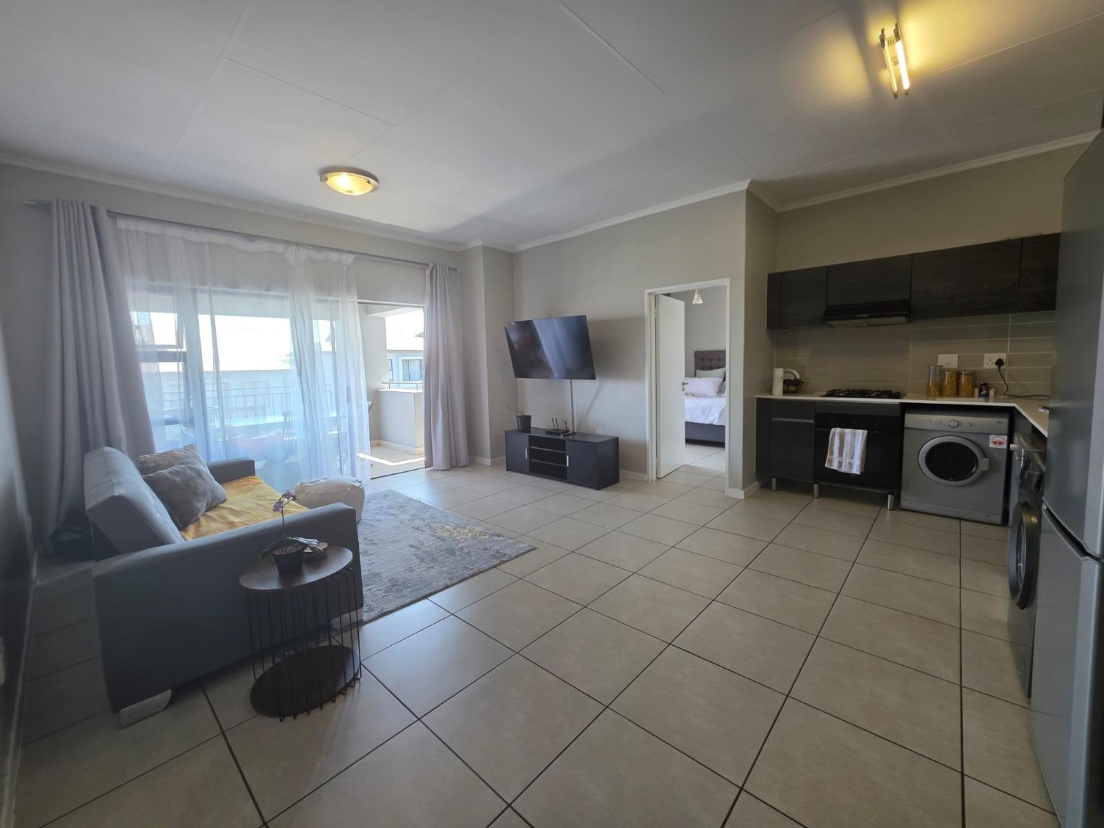 Bright, Modern Apartment with Expansive Balcony in sought after Lifestyle Complex