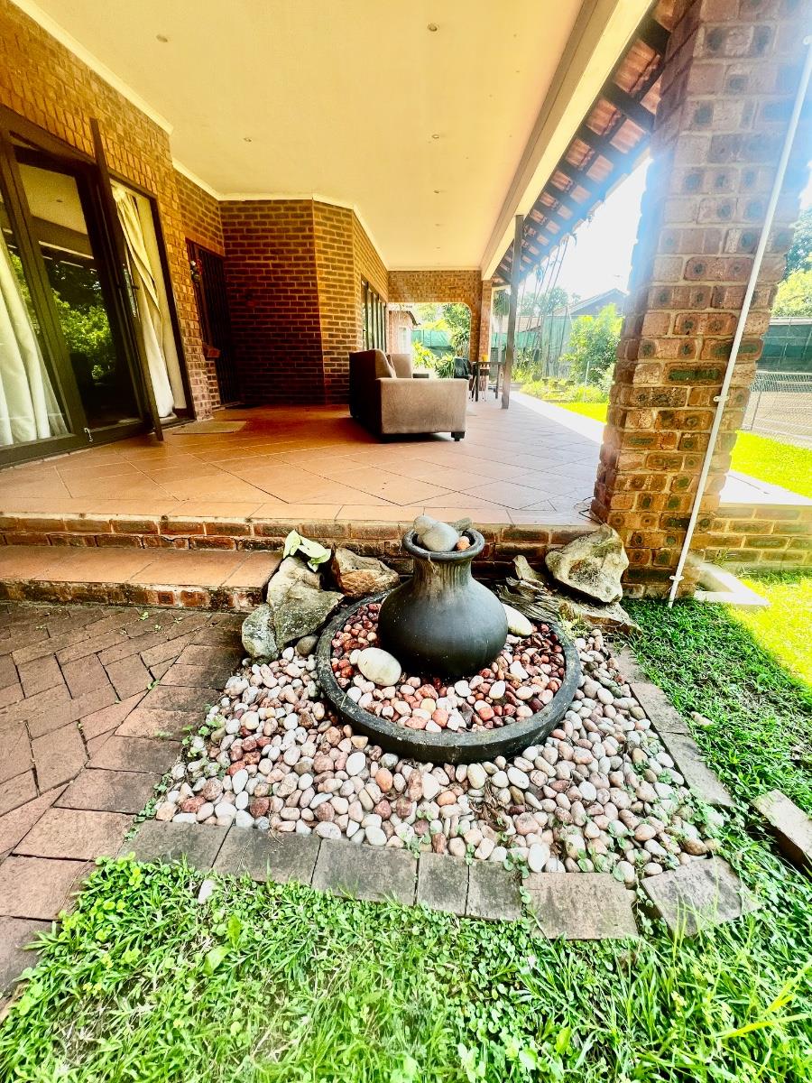 Exceptional lifestyle home with tennis court, entertainment wing, pool, and flatlet