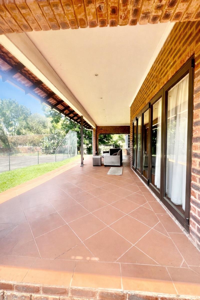 Exceptional lifestyle home with tennis court, entertainment wing, pool, and flatlet