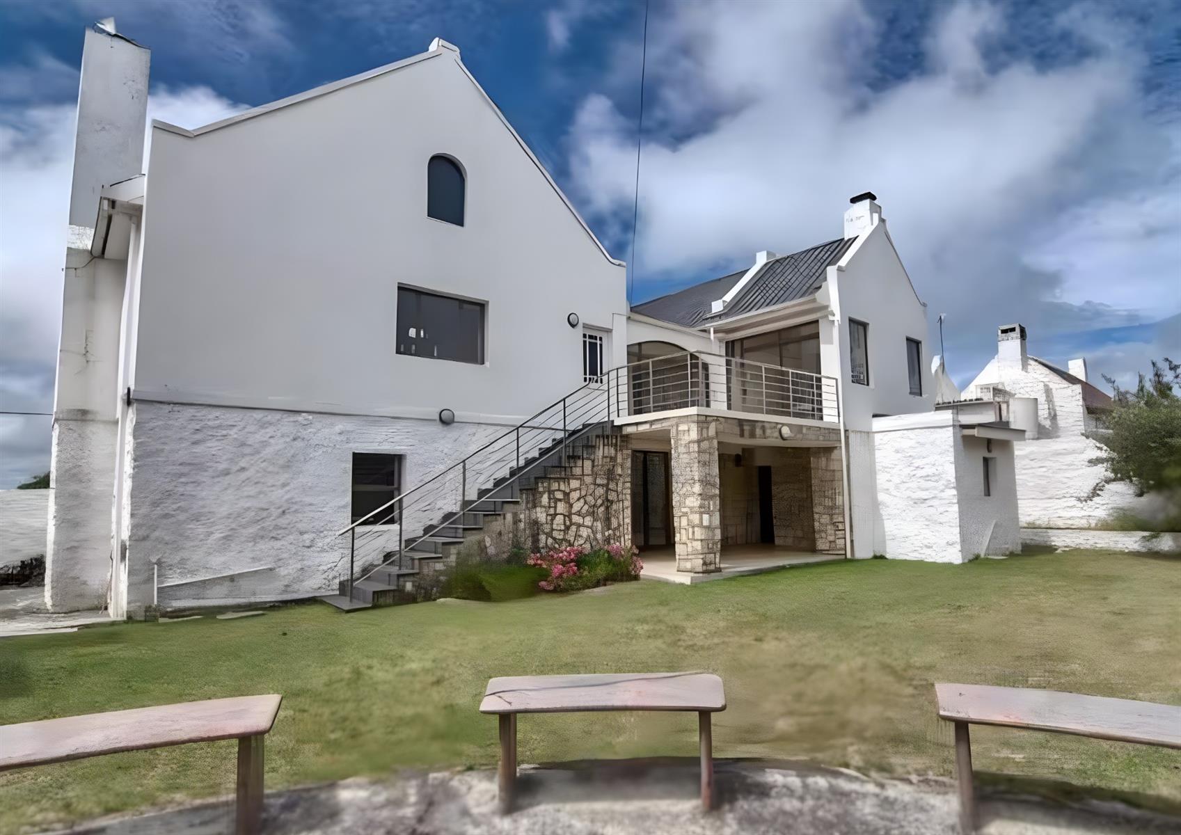 Coastal Elegance Redefined: A Lavish 4-Bedroom Holiday Home with Partial Sea Views in Arniston