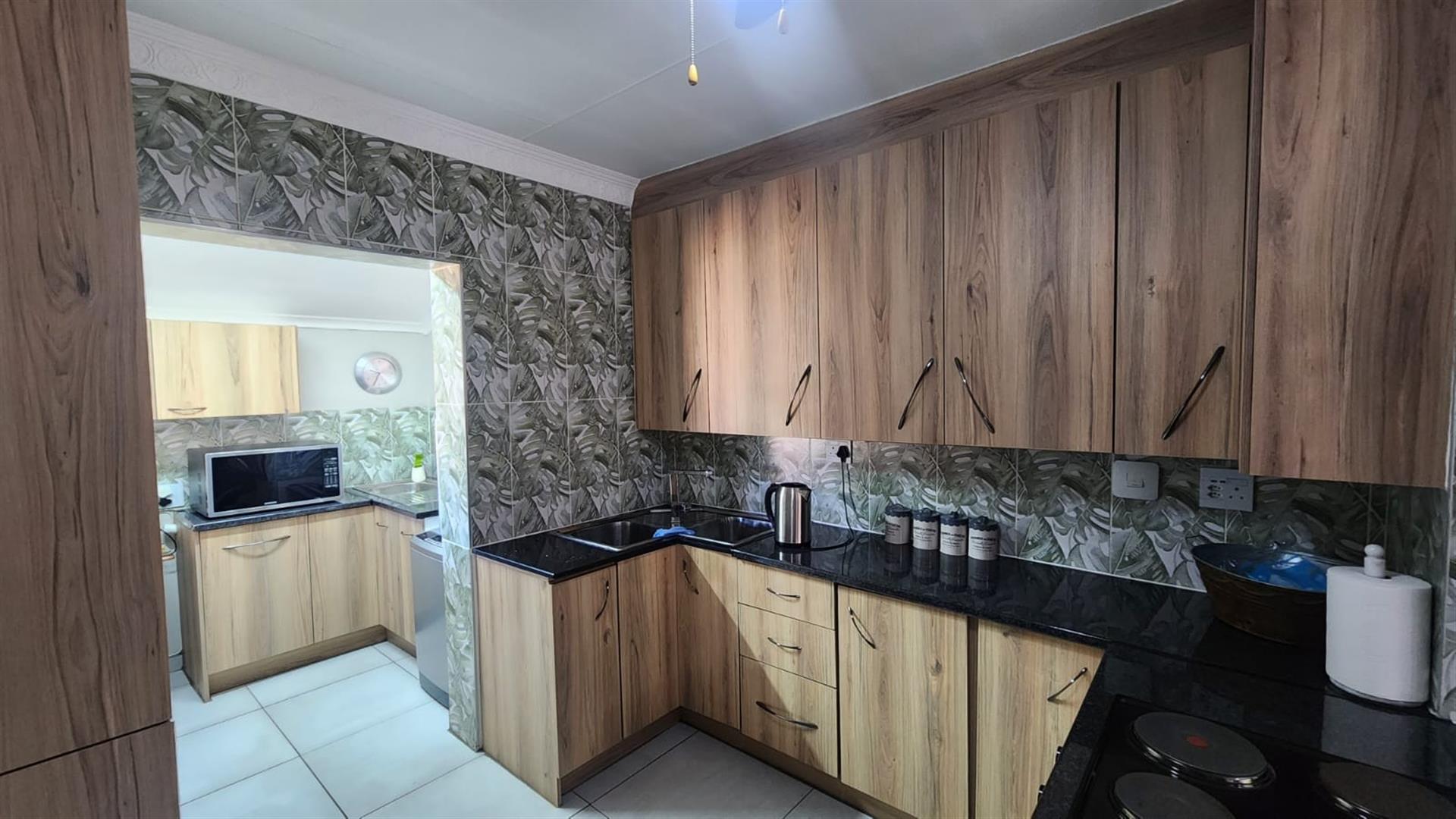Modern Comfort and Secure Living in Sought-After Pin Oaks
